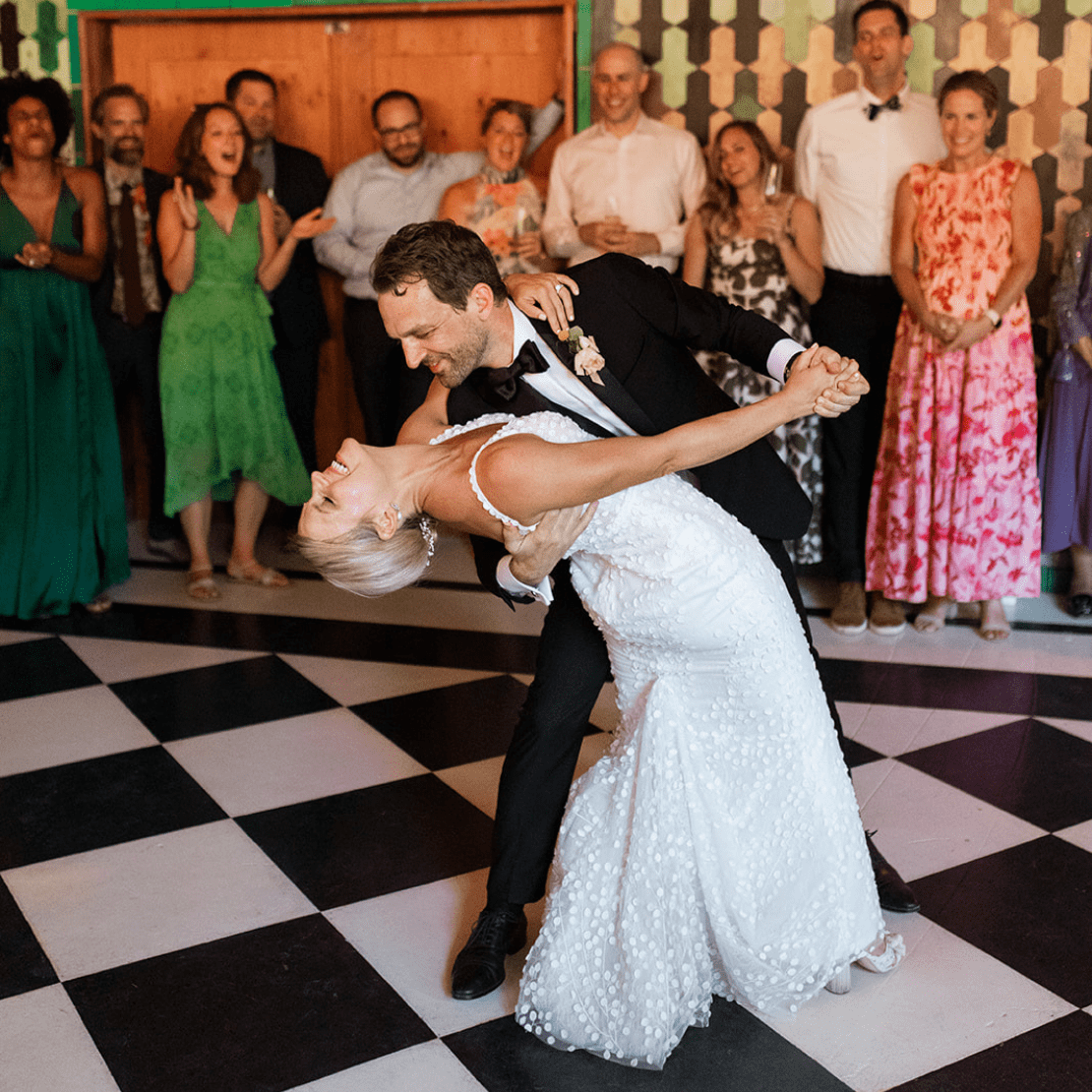 PNW Wedding Dance - PNW Weddings - Choreographer Entertainment - Oregon Washington Idaho - Chekered Floor Dip Black Suit And Tie Vintage Dance Floor Floral Dress Boutonniere-min PDX Flash Mob