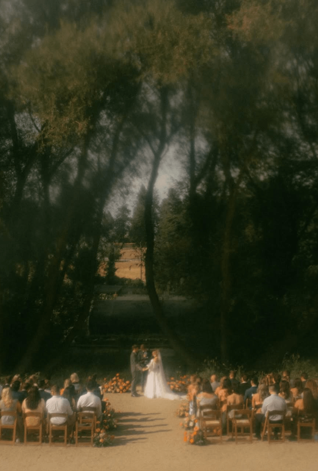 Barn And Blossom Nursery-PNW Weddings-Bride And Groom Exchange Vows In Forest Venue In Spokane