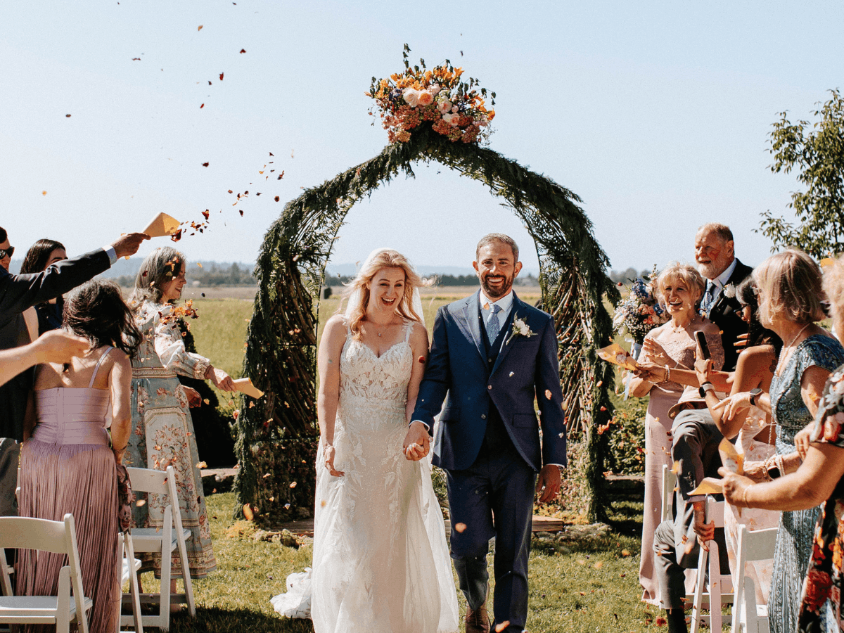 Twinflower Design - PNW Weddings - Wedding Guests Cheers To Bride And Groom Exiting Ceremony