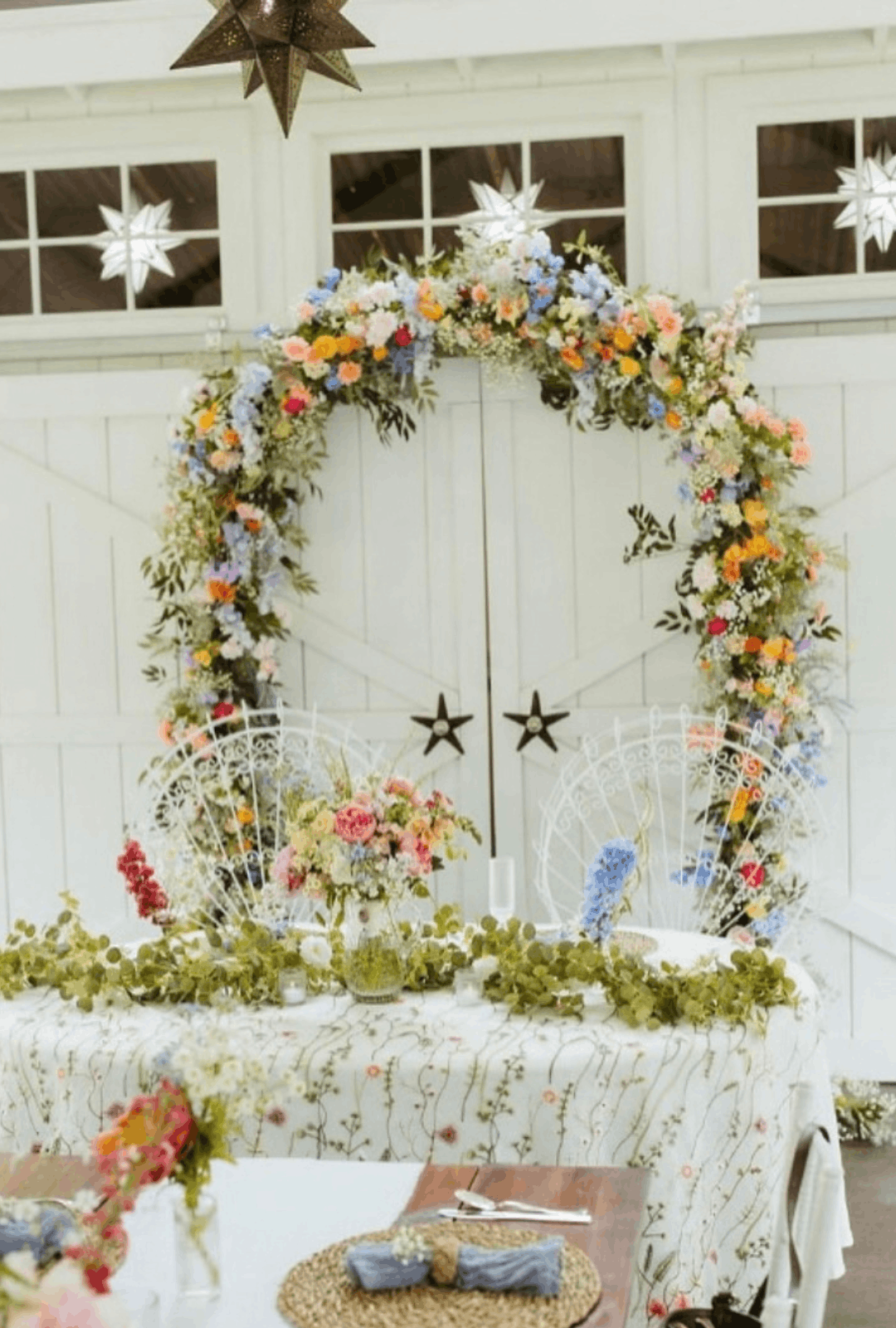 PNW Weddings -Elaborate Events-Wedding Reception Tables Covered In Vibrant Florals At Starlight Meadows In Bothell Washington